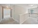 Hallway with a carpet floor and white banisters that leads to the bedrooms at 172 Mill Creek Dr, Canton, GA 30115