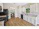 Bright kitchen featuring white cabinets, granite countertops, and modern appliances at 172 Mill Creek Dr, Canton, GA 30115