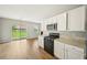 Contemporary kitchen featuring granite countertops and stainless steel appliances with a backyard view at 172 Mill Creek Dr, Canton, GA 30115