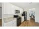 Well-lit kitchen with white cabinets, granite countertops, and stainless steel appliances at 172 Mill Creek Dr, Canton, GA 30115