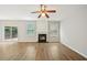 Open living room with fireplace, wood flooring, and access to the backyard patio at 172 Mill Creek Dr, Canton, GA 30115