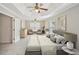 Main bedroom with a tray ceiling, ceiling fan, and furniture at 172 Mill Creek Dr, Canton, GA 30115