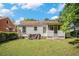 View of the backyard with a large lawn and a screened in porch at 2447 Crestview Ave, Decatur, GA 30032
