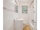 A bathroom with white tile walls, a tub/shower combo, and a single sink vanity at 2447 Crestview Ave, Decatur, GA 30032