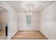 Dining room featuring an archway, hardwood floors, and charming light fixture at 2447 Crestview Ave, Decatur, GA 30032
