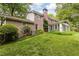 Brick home exterior with sunroom, lush lawn, and mature trees creating a private, serene backyard setting at 295 Glen Lake Dr, Atlanta, GA 30327