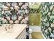 Bathroom with floral wallpaper, single vanity, and a shower-tub combo at 295 Glen Lake Dr, Atlanta, GA 30327