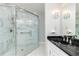 Modern bathroom with glass enclosed shower, marble tile, and double sink vanity at 295 Glen Lake Dr, Atlanta, GA 30327