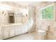 Classic bathroom featuring a double sink vanity, floral wallpaper, and a tiled floor at 295 Glen Lake Dr, Atlanta, GA 30327