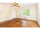 Bedroom featuring hardwood floors, ceiling fan, and a window providing natural light at 295 Glen Lake Dr, Atlanta, GA 30327