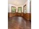 Cozy dining room with wood paneling, large windows, hardwood floors and stylish chandelier at 295 Glen Lake Dr, Atlanta, GA 30327