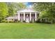 Classic brick home with large white columns, black shutters, and well-manicured lawn at 295 Glen Lake Dr, Atlanta, GA 30327