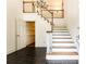 Bright foyer featuring tile floors, staircase, chandelier, and paneled doors at 295 Glen Lake Dr, Atlanta, GA 30327