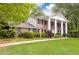 Elegant brick home featuring stately white columns, classic black shutters, and a meticulously manicured front lawn at 295 Glen Lake Dr, Atlanta, GA 30327