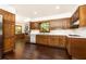 Traditional kitchen with wood cabinets, modern appliances, and hardwood flooring at 295 Glen Lake Dr, Atlanta, GA 30327