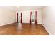 Spacious living room with hardwood floors, and bright windows featuring vibrant red curtains at 295 Glen Lake Dr, Atlanta, GA 30327