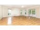 Bright, sunlit living room with hardwood floors, large windows, and access to outdoor space at 295 Glen Lake Dr, Atlanta, GA 30327