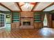 Spacious living room with brick fireplace, wood beam ceiling, and custom built-in shelving at 295 Glen Lake Dr, Atlanta, GA 30327