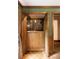 View of the wet bar with wood cabinets, counter, and decorative backsplash at 295 Glen Lake Dr, Atlanta, GA 30327