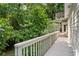 Back deck with railing surrounded by forest canopy at 411 Woodstone West Dr, Marietta, GA 30068
