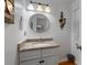Charming bathroom with granite countertops, round mirror, and decorative lighting fixtures at 411 Woodstone West Dr, Marietta, GA 30068