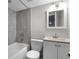 Bathroom with shower and tub combination, gray tiling, and modern sink at 411 Woodstone West Dr, Marietta, GA 30068