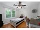 Bedroom featuring a twin bed, desk, and large window with natural light at 411 Woodstone West Dr, Marietta, GA 30068