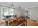 Bright dining room with hardwood floors, a rustic table, and large windows at 411 Woodstone West Dr, Marietta, GA 30068