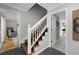 Elegant entryway featuring wood stairs with white railings and views to living room at 411 Woodstone West Dr, Marietta, GA 30068