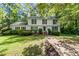 Charming two-story home with black shutters and a well-manicured front yard at 411 Woodstone West Dr, Marietta, GA 30068