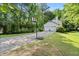 House exterior featuring a long driveway, basketball hoop, and a two-car garage at 411 Woodstone West Dr, Marietta, GA 30068