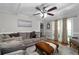 Comfortable living room with plush sofa, hardwood floors, and large windows at 411 Woodstone West Dr, Marietta, GA 30068