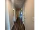 Hallway with an attic access and wood floors at 8656 Webb Rd, Riverdale, GA 30274