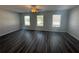 Spacious living room featuring a ceiling fan and large windows at 8658 Webb Rd, Riverdale, GA 30274