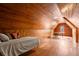 Cozy finished attic room with hardwood floors, wood paneling, and sleeping and work space at 1791 Melrose Sw Dr, Atlanta, GA 30310