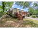 View of the back of the house with wooden deck and staircase at 1791 Melrose Sw Dr, Atlanta, GA 30310