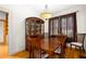 Traditional dining room with hardwood floors, built-in china cabinet, and elegant lighting at 1791 Melrose Sw Dr, Atlanta, GA 30310