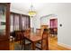 Traditional dining room with hardwood floors, built-in china cabinet, fireplace, and elegant lighting at 1791 Melrose Sw Dr, Atlanta, GA 30310