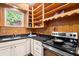 Galley kitchen with white cabinets, stainless steel appliances, and black granite countertops at 1791 Melrose Sw Dr, Atlanta, GA 30310