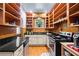 Functional kitchen with light cabinets, a black countertop, and lots of open shelves at 1791 Melrose Sw Dr, Atlanta, GA 30310