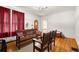 Cozy living room with hardwood floors, ample seating, and natural light from red curtains at 1791 Melrose Sw Dr, Atlanta, GA 30310
