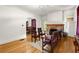 Bright living room with hardwood floors, a stone fireplace, and access to the dining area at 1791 Melrose Sw Dr, Atlanta, GA 30310