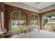 Screened porch with brick arches, neutral table and concrete flooring at 1791 Melrose Sw Dr, Atlanta, GA 30310