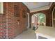 Enclosed porch featuring brick archways, red brick and concrete floors at 1791 Melrose Sw Dr, Atlanta, GA 30310