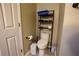 Simple bathroom features toilet and dark shelving for towel storage at 120 Clifford Ct, Canton, GA 30115