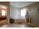 Bathroom featuring corner bathtub, tile floors, and glass enclosed shower at 120 Clifford Ct, Canton, GA 30115