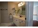 Bathroom with a white vanity, large mirror, sconce lighting, and tiled floors at 120 Clifford Ct, Canton, GA 30115