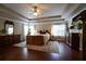 Spacious primary bedroom boasts tray ceilings, ceiling fan, and hardwood floors at 120 Clifford Ct, Canton, GA 30115