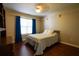 Cozy bedroom with blue curtains, hardwood floors, and natural light at 120 Clifford Ct, Canton, GA 30115
