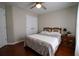 Bedroom featuring a bed, wood floors, ceiling fan, and double door closet at 120 Clifford Ct, Canton, GA 30115
